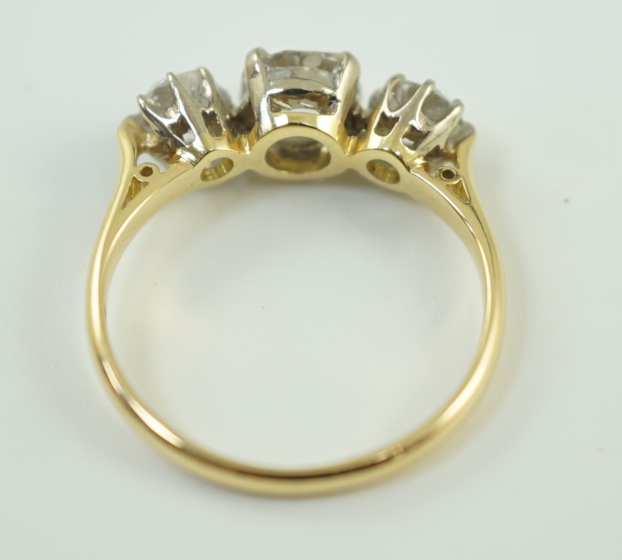 A modern 18ct gold and three stone diamond set ring